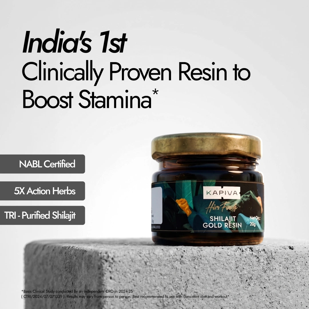 Jar of Kapiva Shilajit Gold Resin on a concrete surface with promotional text about its benefits.